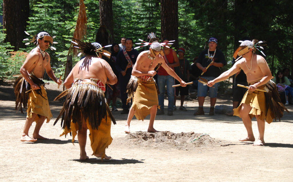 Five Native American men in traditional dance