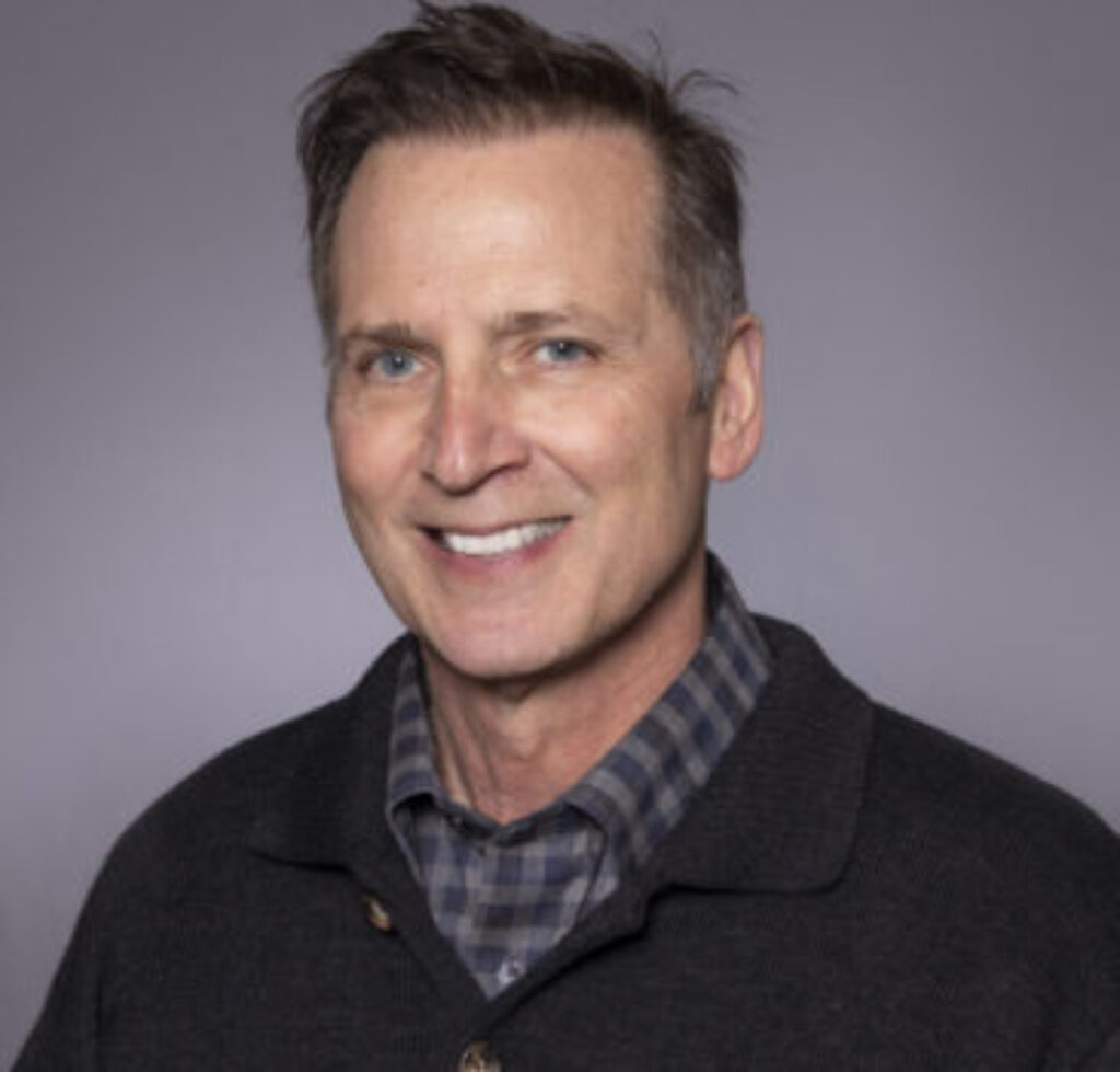 a headshot of Dennis