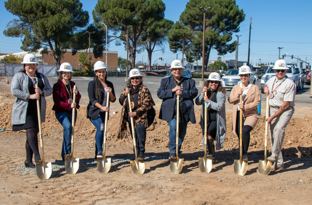 Board of directors with shovels at construction site