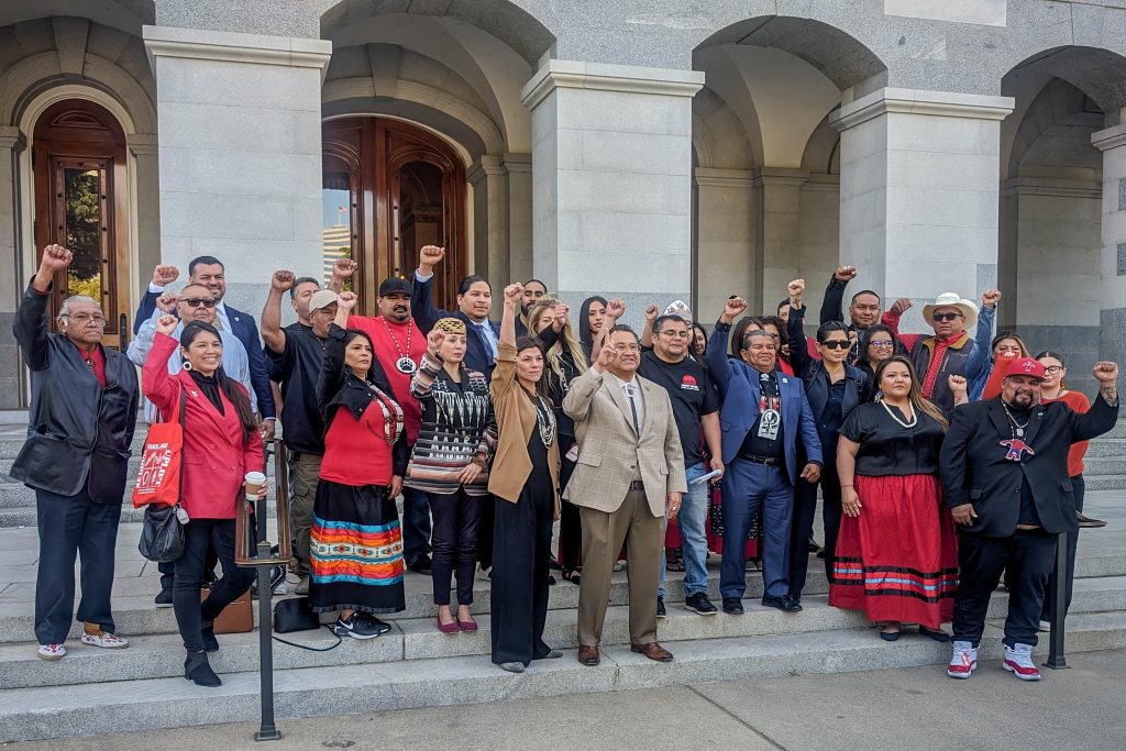 Tribal leaders raise fists in solidarity with the MMIP movement.