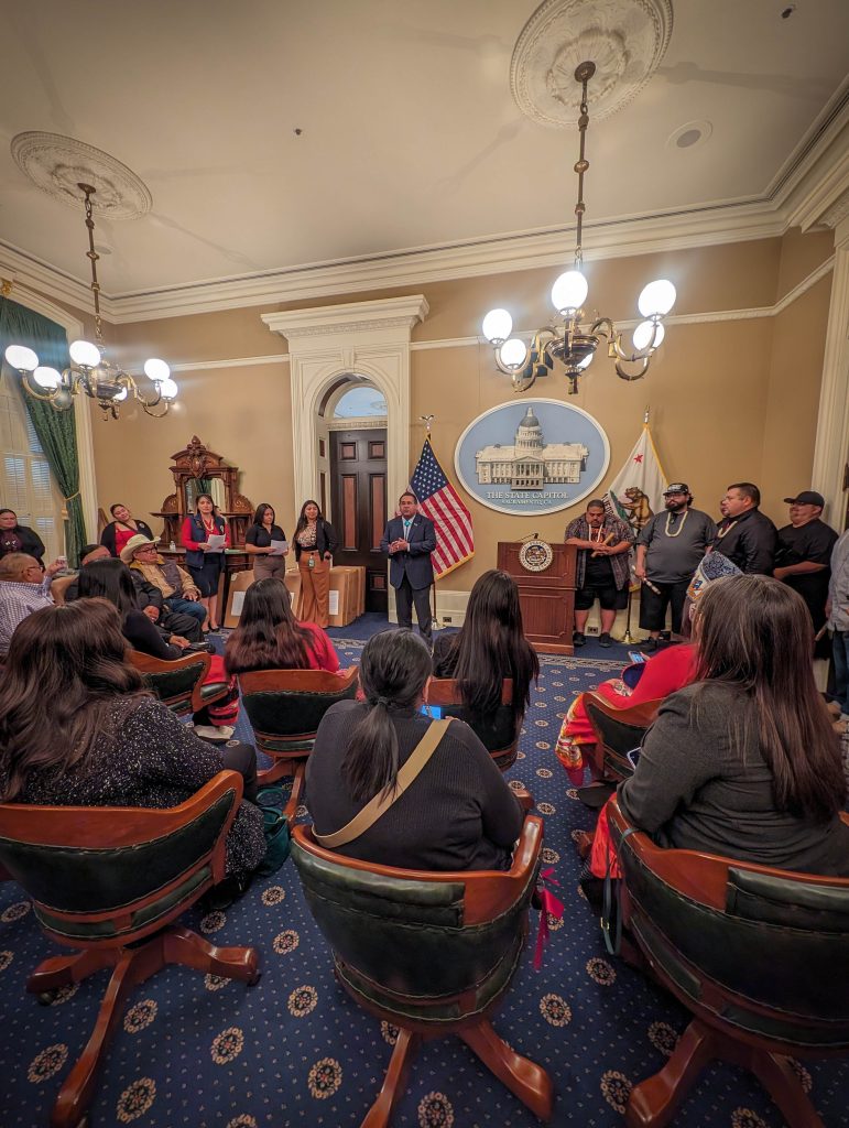Tribal leaders gathered in a State Capitol room.
